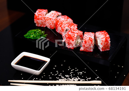 Sushi with salmon. Soy sauce, red caviar. Sushi on a black background. Sushi with salmon. Soy sauce, red caviar. Sushi on a black background. 68134191