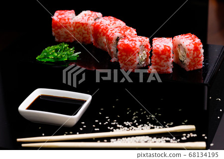 Sushi with salmon. Soy sauce, red caviar. Sushi on a black background. Sushi with salmon. Soy sauce, red caviar. Sushi on a black background. 68134195