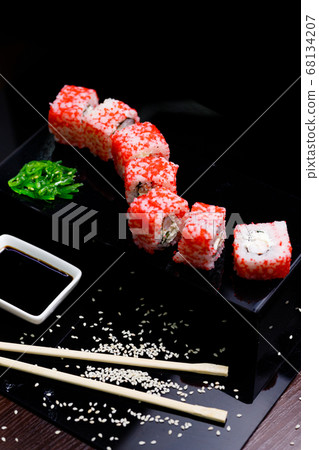 Sushi with salmon. Soy sauce, red caviar. Sushi on a black background. Sushi with salmon. Soy sauce, red caviar. Sushi on a black background. 68134207