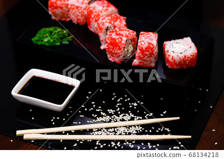 Sushi with salmon. Soy sauce, red caviar. Sushi on a black background. Sushi with salmon. Soy sauce, red caviar. Sushi on a black background. 68134218