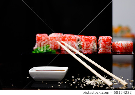 Sushi with salmon. Soy sauce, red caviar. Sushi on a black background. Sushi with salmon. Soy sauce, red caviar. Sushi on a black background. 68134222