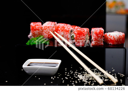 Sushi with salmon. Soy sauce, red caviar. Sushi on a black background. Sushi with salmon. Soy sauce, red caviar. Sushi on a black background. 68134226
