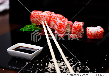 Sushi with salmon. Soy sauce, red caviar. Sushi on a black background. Sushi with salmon. Soy sauce, red caviar. Sushi on a black background. 68134228
