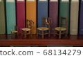 wedding rings are hanging on the play chairs on the background of books 68134279