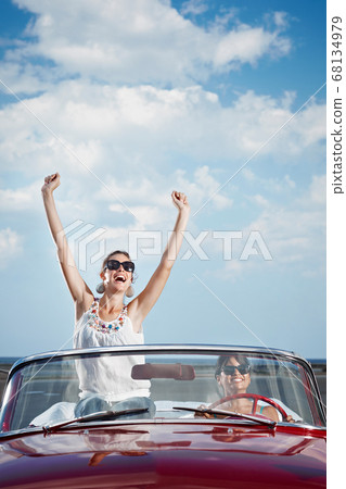 Happy Women Driving Rented Convertible Car For Vacations Happy Women Driving Rented Convertible Car For Vacations 68134979