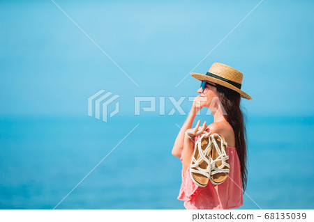 Young beautiful woman having fun on tropical seashore. Young beautiful woman having fun on tropical seashore. 68135039
