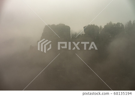 Sharp mountains cliffs disappeared in the low 68135194