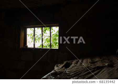 Light enters a dark barn through a small window in Light enters a dark barn through a small window in 68135442