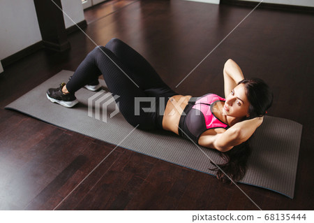 Fit woman doing sport exercises in her living room 68135444