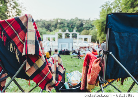 two folding chairs with cooling bag with beer and snacks in open air cinema two folding chairs with cooling bag with beer and snacks in open air cinema 68135983