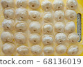 Homemade Dumplings lie on the baking tray in rows 68136019