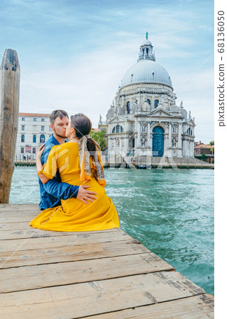 couple hugging on pier with view of grand canal saint maria church on background couple hugging on pier with view of grand canal saint maria church on background 68136050