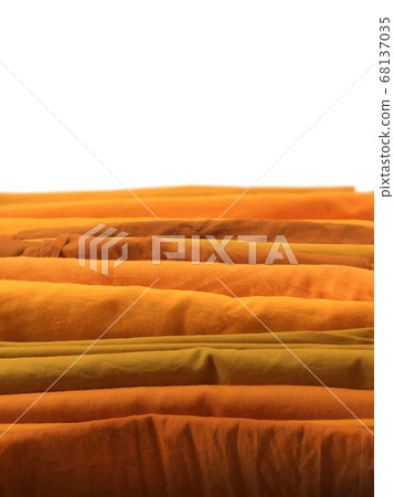 Yellow robe in many Earth tone for monk on white background. 68137035