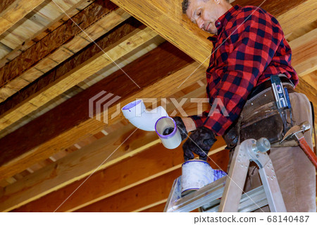 Plumber gluing PVC plastic sewer toilet white pipe Plumber gluing PVC plastic sewer toilet white pipe 68140487