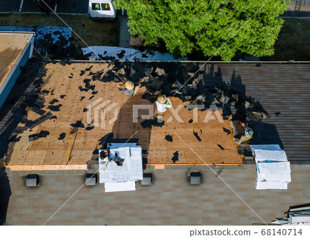 Working roofers on replacing the roof of Working roofers on replacing the roof of 68140714