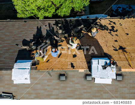 Roofer replace shingle that has been damaged and 68140883