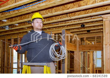 Connecting a new home an electrician works for a 68141589
