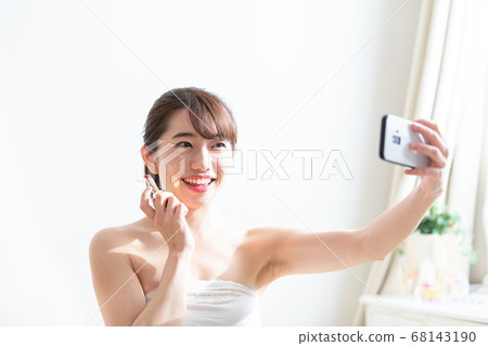 Woman taking a selfie 68143190
