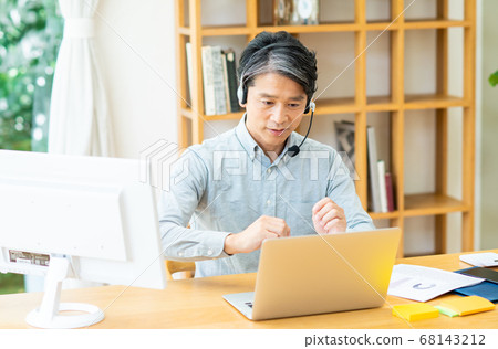 Middle-aged man teleworking 68143212