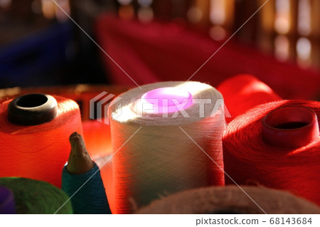 lighting shadow on yarn spools on bamboo basket 68143684
