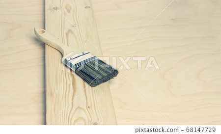 Paint brush on unpainted pine board on wooden background Paint brush on unpainted pine board on wooden background 68147729