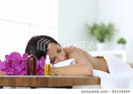 Relaxed woman in spa lies after massage closeup 68149484