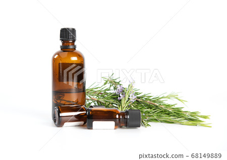Bottle of rosemary essential oil with fresh 68149889