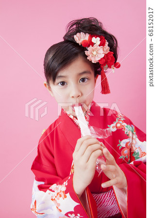 Girl eating Chitose candy 68152017