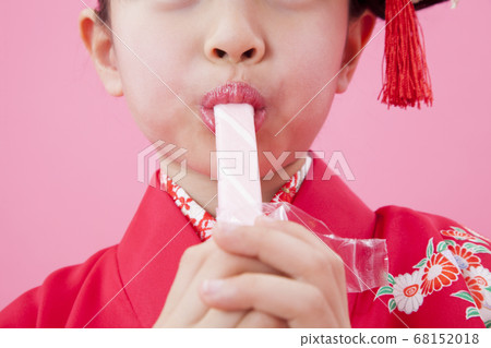 Girl eating Chitose candy 68152018