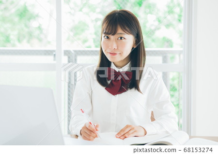 Schoolgirl taking an online class Schoolgirl taking an online class 68153274