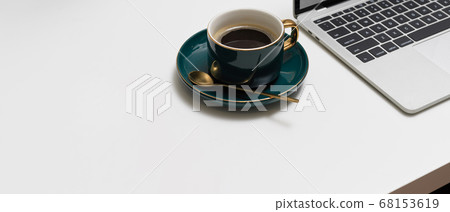 Workspace with green ceramic coffee cup, laptop Workspace with green ceramic coffee cup, laptop 68153619