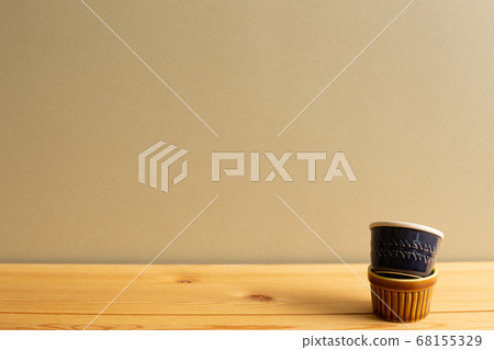Stack of ceramic bowls on wooden table with brown background Stack of ceramic bowls on wooden table with brown background 68155329