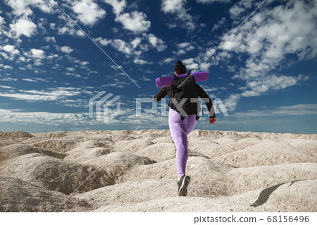 young woman one tourist running, rear view on hill area in sportswear and with backpack looking into distance on sunny day, concept of healthy lifestyle, sports, overcoming obstacles young woman one tourist running, rear view on hill area in sportswear and with backpack looking into distance on sunny day, concept of healthy lifestyle, sports, overcoming obstacles 68156496