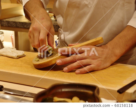 Hands of a sushi chef to grate wasabi Hands of a sushi chef to grate wasabi 68158118
