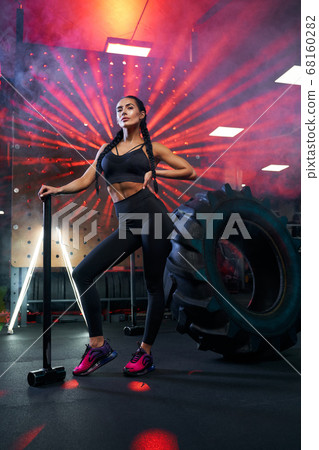 Female bodybuilder posing with sledgehammer. Female bodybuilder posing with sledgehammer. 68160282