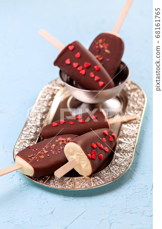 Homemade ice cream on a stick with chocolate Homemade ice cream on a stick with chocolate 68161765