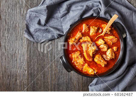 Caribbean stewed pork ribs in a ceramic pan 68162487