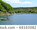 People enjoying fishing on a small boat Lake Motosu 68163082