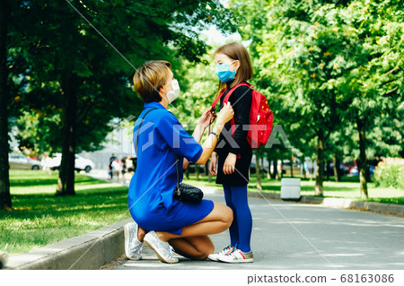 Back to school. Mother seeing off her child. 68163086