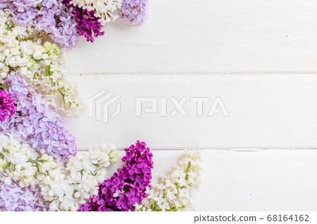 Lilac flowers branch on white wooden background with copyspace. 68164162