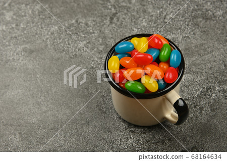 Multicolor jelly beans in mug on table Multicolor jelly beans in mug on table 68164634