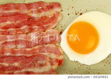 Close up sunny side egg and bacon on plate 68164681