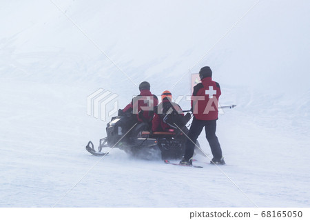 Lifeguards on a snowmobile in the fog. 68165050