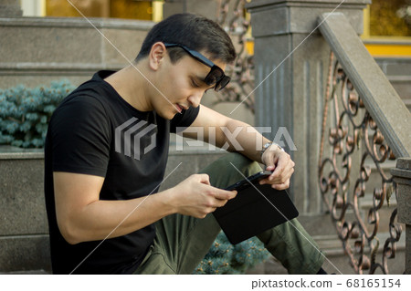 young funny asian man in town outdoor lifestyle young funny asian man in town outdoor lifestyle 68165154