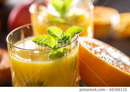 Two glasses with orange or multivitamin juice with Two glasses with orange or multivitamin juice with 68166110