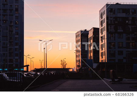 Apartment buildings at sunset. Residential district cityscape in evening Apartment buildings at sunset. Residential district cityscape in evening 68166326