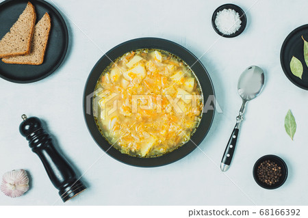 Chicken soup on black bowl on dark black stone Chicken soup on black bowl on dark black stone 68166392