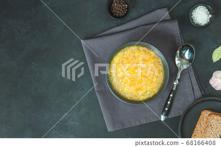 Chicken soup on black bowl on dark black stone Chicken soup on black bowl on dark black stone 68166408