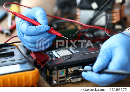 Electrician repairs on the table from the computer Electrician repairs on the table from the computer 68166575