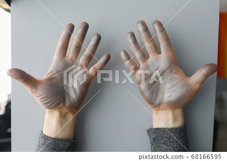 Close up of hands stained with silver paint Close up of hands stained with silver paint 68166595